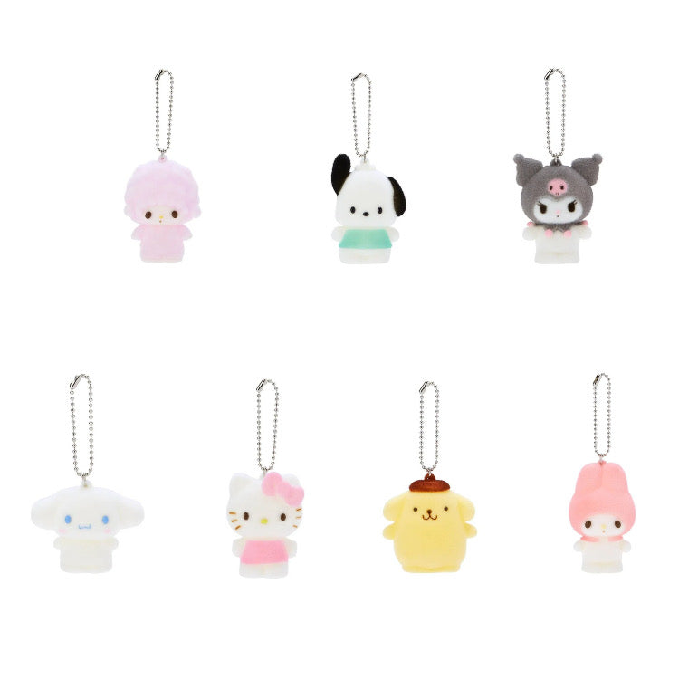 A collection of Sanrio themed fuzzy squishy toy charms attached to keychains, including designs resembling animals and cartoon characters.